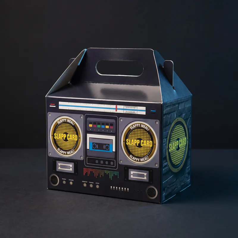 The boombox-printed box with a carry handle and a round Slappcard sticker over each speaker